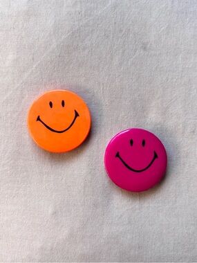 1990s neon orange and dark magenta pink smiley face button pins